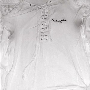 white criss cross shirt with saying “los angeles”